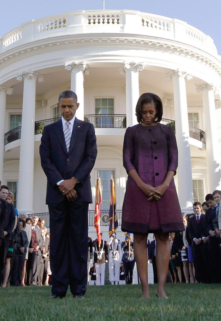 Image: U.S. President Barack Obama and first lady Michelle Obama observe a moment of silence on the 11th anniversary of the 9/11 attacks in Washington